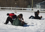 Students grappling in the snow