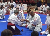 Sensei Manoli receiving 6th Dan in Kenkokan and 7th Dan in Koshiki