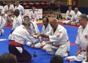 Sensei Manoli receiving 6th Dan in Kenkokan and 7th Dan in Koshiki