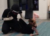 Morneau/Chepell 'hands-on', simulation oriented, women's self-defence workshop. Second group of wild, motivated and determined women. Downtown Montreal, Canada. Most attacks end up in a horizontal position (ground, bed, table...). Know what to do if brought to the ground. Get your legs between you and him. - Oct. 2019